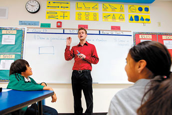 Navajo Middle School math teacher Kyle Guillet speaks to his class on Thursday, Feb. 24. Guillet is one of several Teach for America teachers that work at the school. &copy; 2011 Gallup Independent / Brian Leddy 
